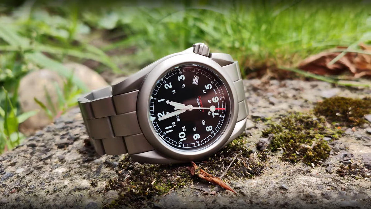 A titanium automatic outdoor watch on a stone in the wild